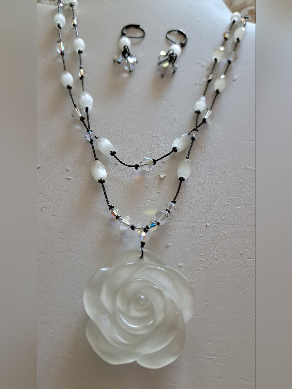 Delicate White Rose Pendant Necklace With Crystals along With Matching Earrings.